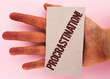 Text sign showing Procrastination Motivational Call. Conceptual photo Delay or Postpone something boring written Cardboard Piece placed Hand the plain background.