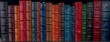 A Stack Of Beautiful Leather Bound Books With A Black Background.