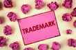 Conceptual hand writing showing Trademark. Business photo showcasing Legally registered Copyright Intellectual Property Protection written Sticky Note Paper plain background Paper Balls.
