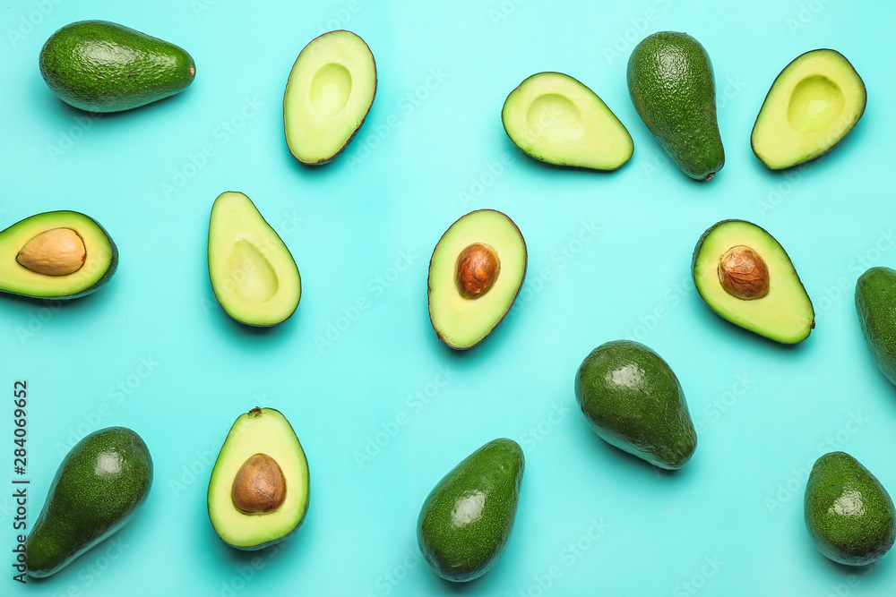 Fresh avocados on color background