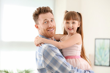 Poster - Portrait of happy father and his little daughter at home