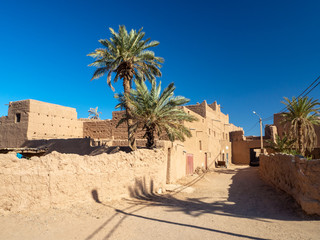 Desert town of Mhamid, Morocco village with nature sand dunes and old muslim mosque in north Africa, old narrow streets, traditional clay mud architecture