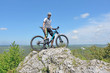 Zborów Mountain, Poland. Man on top of a mountain on a bike.
