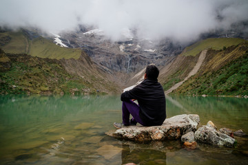 man in front of the Humantay Lake on the Salkantay Trail, the trek to Machu Picchu, Peru