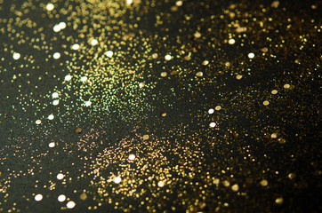 Wall Mural - Golden sparkles on black background. Festive concept. - Image