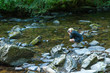 Young photographer taking photos in Tarr Steps Woodland Reserve