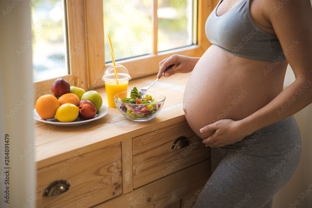 Pregnant lady eating healthy food at home - obrazy, fototapety, plakaty 