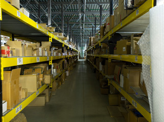 Warehouse interior with shelves, pallets , boxes and equipment