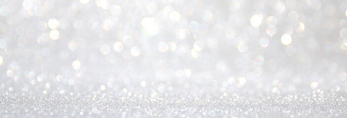 background of abstract glitter lights. silver and white. de-focused