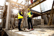 © romul014 - Men in hardhat and green jacket posing on building site.