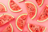 Juicy slices of red watermelon on a bright pink background. Conceptual colors of summer. Patterns top view as a background or substrate