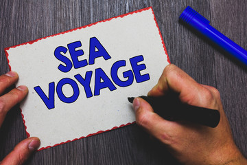 Writing note showing Sea Voyage. Business photo showcasing riding on boat through oceans usually for coast countries Man holding marker paper red borders express ideas Wooden background