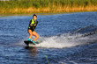 Young Sexy girl Catch waves on wakeboard when boat pulls a wakeboard 