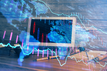 Double exposure of graph and financial info and work space with computer background. Concept of international online trading.