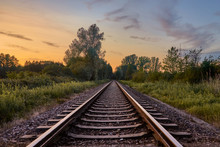 Train Tracks In Front Of Nature And The Beautiful Sunset Sky