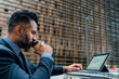 © HEX./Stocksy - Elegant Adult Businessman Drinking a Coffee and working on His L
