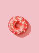 © Sergey Melnikov/Stocksy - Delicious donut on pink