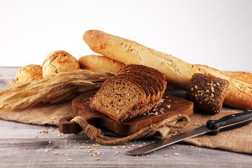 freshly baked bread on wooden board. cutted organic bread