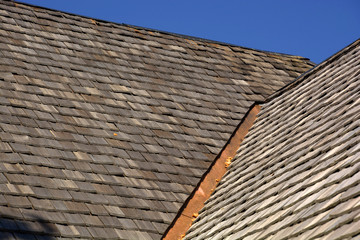 new wood shingle roof with copper gutter, wood shingles on a roof top of an old hut in bavaria