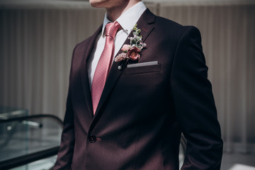 Wall Mural - the groom in a suit and tie with a boutonniere