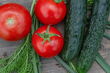 tomatoes and cucumbers on wooden background