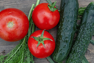 tomatoes and cucumbers on wooden background