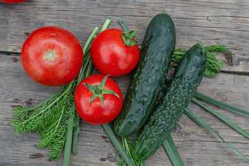 tomatoes and cucumbers on wooden background