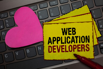Writing note showing Web Application Developers. Business photo showcasing Internet programming experts Technology software Red bordered yellow written paper pinch with love on computer keybaord