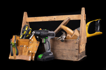 Old wooden tool box. Various DIY accessories on a workbench.