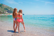 © travnikovstudio - Two little happy girls have a lot of fun at tropical beach playing together