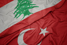 Waving Colorful Flag Of Turkey And National Flag Of Lebanon.