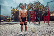 © zamuruev - Athletic man working out with a kettlebell at street gym yard. Strength and motivation. Outdoor workout. Exercise for shoulders.
