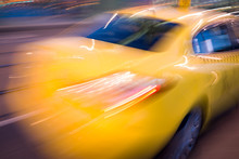Blurred Yellow Taxi Car On The Road