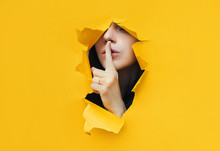 A Young Girl Closes Her Lips With Her Index Finger,making It Clear To The Viewer That You Need To Observe Silence,keep A Secret And Not Say Too Much. Censorship And Harassment Of Freedom Of Speech.