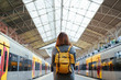 © beavera - Beautiful portuguese woman traveler waiting at train station. Travel and vacation concept. Urban lifestyle.