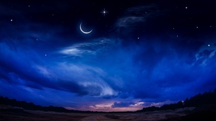 Beautiful dark fluffy cloudy sky with sun rays . Crescent moon with beautiful sunset background . Generous Ramadan . New moon. Prayer time. 