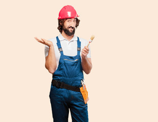 young man worker with a paint brush