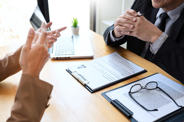 Wall Mural - businessman candidate explaining about his profile and conducting a job to managers sitting in job Interview in modern office, consulting or employment concept.