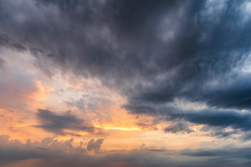 light in the dark and dramatic storm clouds during sunset
