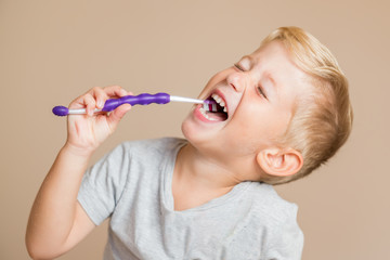 little baby boy with tooth brush,kid boy smiling happiness,dental hygiene and health for children,brown background.