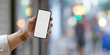 © bongkarn - Close-up view of man showing blank screen smartphone in downtown