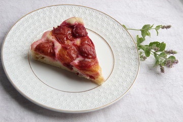 Wall Mural - Slice of plum cake on plate with background