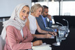 © wavebreak3 - Businesswoman in hijab looking at camera at table in conference