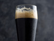 dark beer on a black background close-up. Beer porter