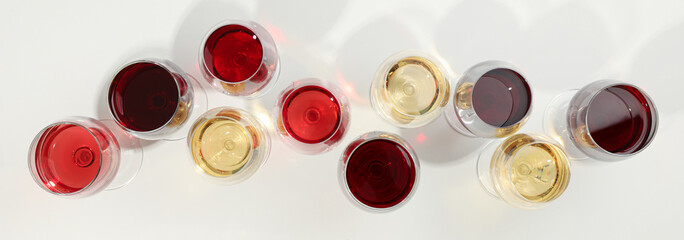 Wall Mural - Flat lay composition. Glasses with different wine on white background, top view