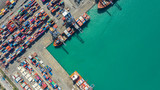 Container ship in export and import business logistics and transportation. Cargo and container box shipping to harbor by crane. Water transport International. Aerial view and top view.