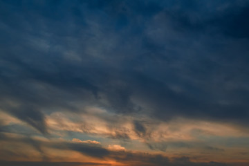 The sky at sunset. Cumulus clouds lit by the rays of the setting sun.