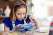 © famveldman - Child at pottery wheel. Kids arts and crafts class