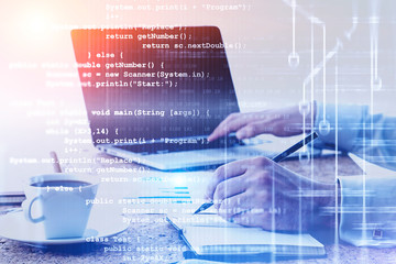 man using laptop and writing code