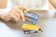 Unidentified woman in white dress holding credit card, personal financial credit, use credit cards instead of cash for manage the cash flow.